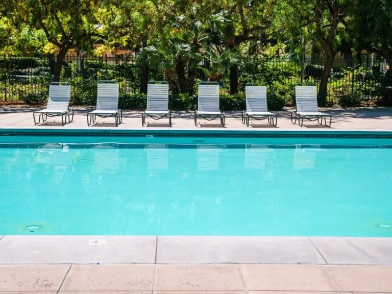 Empty poolside with lounge chairs.